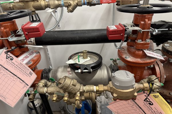 Commercial backflow testing service in St Charles IL - Fox Valley Plumbing certified tester inspecting a backflow prevention assembly